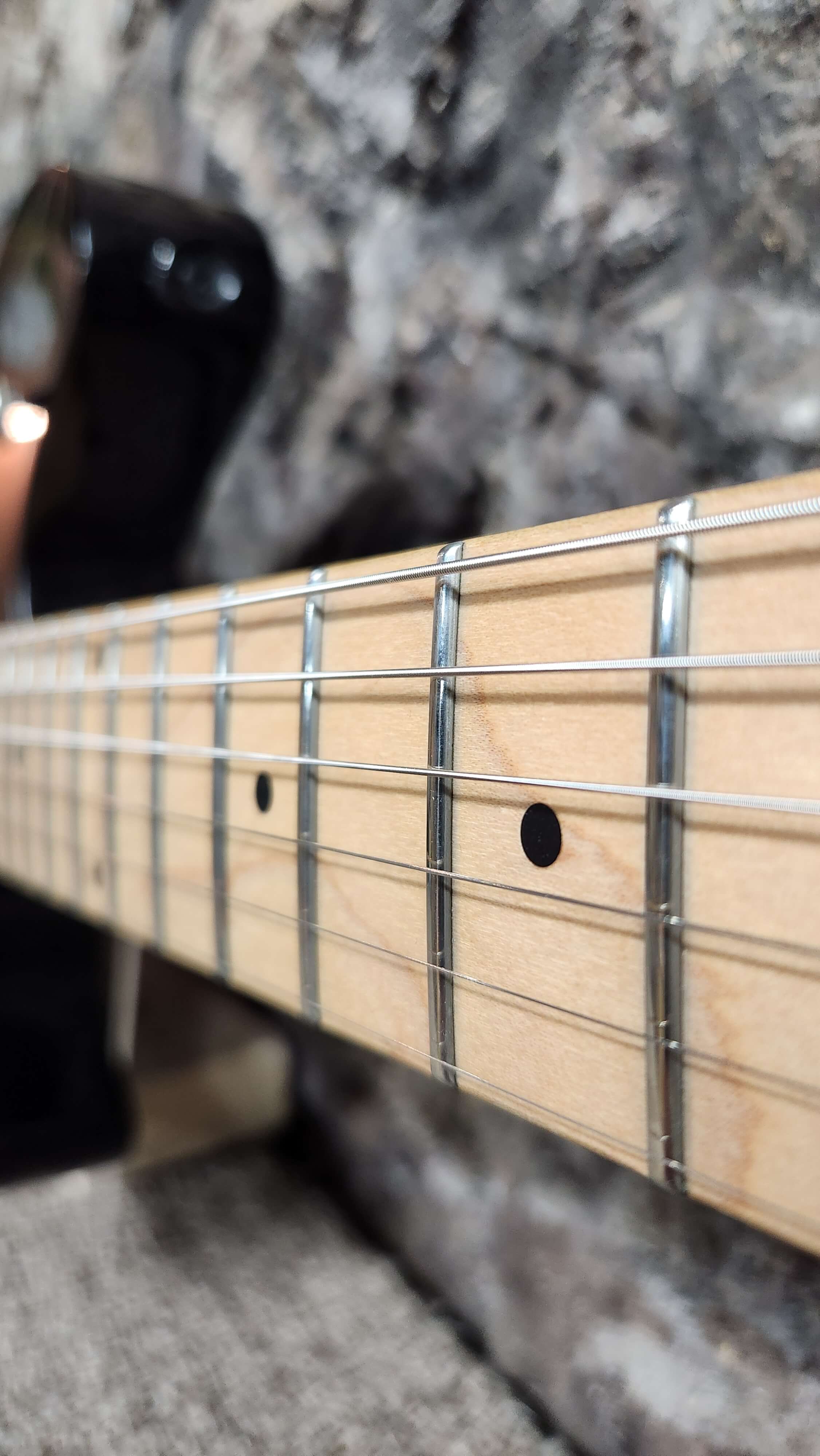 Staring down the neck of an electric guitar with low action - Guitar Setups - Guelph Guitar Repair